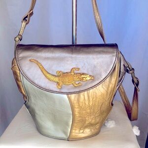 ATALLA gold, bronze, and pewter colored genuine leather handbag.